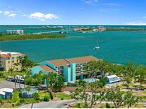 Beautiful aerial view of the condo community with waterfront views and boat access in a tropical setting at 53 W Bay Heights Rd # 307, Englewood, FL 34223