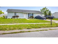 Charming single-story home featuring a well-maintained lawn, front shrubs, and an attached garage at 5983 Hobhill Ave, North Port, FL 34287
