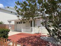 Charming home featuring a brick front porch and well-maintained landscaping at 617 W Olympia Ave, Punta Gorda, FL 33950
