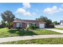 Charming single-story home with a well-manicured lawn, lush landscaping, and inviting curb appeal at 6382 Cutler Ter, Port Charlotte, FL 33981