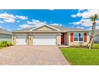 Charming single-story home with a three-car garage, paver driveway, and well-manicured lawn at 1472 Mableton Dr, Port Charlotte, FL 33953