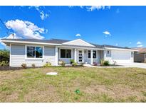 Charming single-story home features a manicured lawn and inviting front entrance, creating excellent curb appeal at 18610 Fort Smith Cir, Port Charlotte, FL 33948