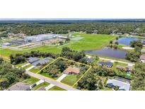 Spacious property with a large backyard, pool, and lush landscaping surrounded by mature trees in a desirable neighborhood at 3305 Nansen Ln, North Port, FL 34286