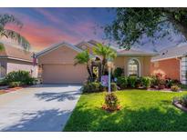 Charming single-story home with well-manicured lawn, mature trees and inviting curb appeal at 1775 Scarlett Ave, North Port, FL 34289