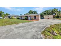 A charming single-story home with a concrete driveway and a well-maintained front yard at 25082 Harborview Rd, Punta Gorda, FL 33980