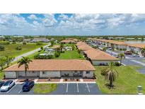 A stunning aerial view of a condo community showcasing well-manicured lawns and a sparkling pool at 25275 Rampart Blvd # 404, Punta Gorda, FL 33983