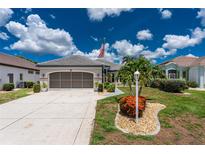 Charming single-story home with a well-manicured lawn, palm trees, and an American flag at 26254 Stillwater Cir, Punta Gorda, FL 33955