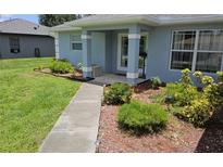 Inviting front entrance with well-maintained landscaping and a charming walkway at 6341 Opa Locka Ln, North Port, FL 34291