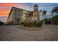 A beautiful mediterranean building with covered parking, brick entrance and tower at 900 E Marion Ave # 1203, Punta Gorda, FL 33950
