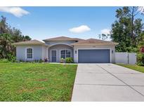 Charming single-story home with a well-manicured lawn and two car garage at 1762 Mincey Ter, North Port, FL 34286