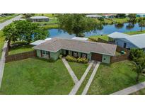Charming single-story home featuring a well-maintained lawn, fenced yard, and convenient two-car garage at 21539 Gladis Ave, Port Charlotte, FL 33952