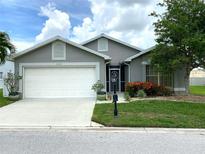 Charming single-story home with well-maintained landscaping and an attached two-car garage at 24132 Buckingham Way, Punta Gorda, FL 33980