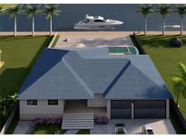 Stunning waterfront home featuring a private pool, boat dock, and beautifully landscaped yard at 24317 Treasure Island Blvd, Punta Gorda, FL 33955