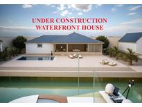 Stunning waterfront house under construction boasts a sleek pool, open living spaces, and modern design at 24317 Treasure Island Blvd, Punta Gorda, FL 33955