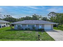 Charming single-story home with a well-maintained lawn, complemented by lush, mature trees for enhanced curb appeal at 3085 Arrowhead Rd, Venice, FL 34293