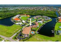 Stunning aerial view of condo complex featuring waterway access and beautiful landscaping at 3221 White Ibis Ct # D1, Punta Gorda, FL 33950