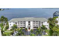Beautiful waterfront condo with a large balcony and lush landscaping, providing stunning views of the bay at 1250 W Marion Ave # 333, Punta Gorda, FL 33950