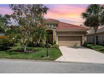 Beautiful single-story home featuring a tile roof, manicured landscaping, and a two-car garage at 13139 Preserve Ct, Port Charlotte, FL 33953