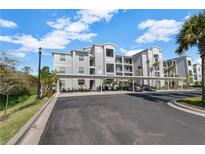 Beautiful multi-story condominium building with assigned covered parking spaces and well-maintained landscaping at 14161 Heritage Landing Blvd # 1122, Punta Gorda, FL 33955