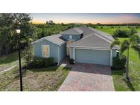 Charming single-Gathering home with a two-car garage and brick paver driveway and lush surroundings at 3631 Pebble Ter, Punta Gorda, FL 33980