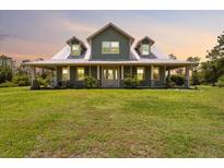 Charming home with a large yard, inviting front porch, and beautiful architectural details at 5242 Blackjack Cir, Punta Gorda, FL 33982