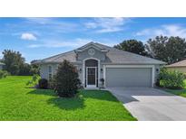 Charming single-story home with a well-manicured lawn and a two-car garage at 96 Mocha Ct, Punta Gorda, FL 33983