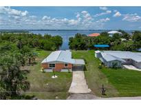Charming waterfront home with a well-maintained yard, carport, and serene water views at 161 Danforth Dr, Punta Gorda, FL 33980