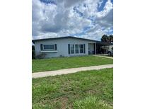 Well-maintained, single-story home with tidy front lawn and car port at 22187 Lasalle Rd, Port Charlotte, FL 33952