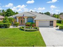 Charming single-story home features a well-manicured lawn and attached two car garage at 26090 Rampart Blvd, Punta Gorda, FL 33983