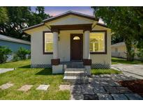 Charming single-Gathering home with a cozy front porch and well-maintained lawn at 2626 E 38Th Ave, Tampa, FL 33610