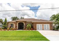 Charming single Gathering home features a beautifully landscaped yard and stone accents on the facade at 4640 W Price Blvd, North Port, FL 34286