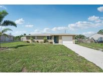 Charming one-story home featuring a well-manicured lawn and an attached garage, creating a welcoming curb appeal at 1107 Seneca Rd, Venice, FL 34293