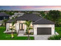 Beautiful single-story home with meticulously maintained landscaping, inviting entrance, and a two-car garage at 14166 Fort Worth Cir, Port Charlotte, FL 33981