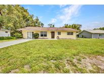 Charming single-story home featuring a well-maintained lawn and inviting curb appeal in a lovely neighborhood at 1478 Harmony Dr, Port Charlotte, FL 33952
