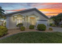 Charming single-story home with a well-maintained lawn and beautiful sunset sky at 1617 Britannia Blvd, Punta Gorda, FL 33980