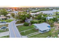 Lovely single-story home with mature trees, green lawn, and a convenient covered parking area at 180 Palmetto Ne Cir, Port Charlotte, FL 33952