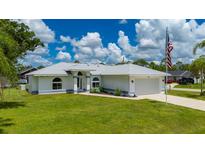 Charming single Gathering home with manicured lawn and attached two car garage at 1865 Rival Ter, North Port, FL 34286