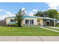 Charming home with a well-maintained front yard, inviting entrance and a carport at 22341 Midway Blvd, Port Charlotte, FL 33952