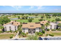 Enjoy this condo community with views of lush landscaping and a pond on a golf course at 26336 Nadir Rd # 10, Punta Gorda, FL 33983