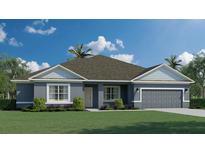 Charming one-story home showcasing a well-manicured lawn, gray exterior, and attached garage at 3984 Junction St, North Port, FL 34288