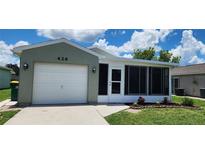 Charming single-story home with a well-maintained lawn and a one-car garage at 426 Ricold Ter, Port Charlotte, FL 33954