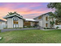 Beautiful two-story home with a well-manicured lawn and stone facade, perfect for curb appeal at 4460 Northshore Dr, Punta Gorda, FL 33980