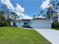 Charming single-story home featuring a well-manicured lawn and an attached two-car garage at 8530 Sawyer Cir, North Port, FL 34288