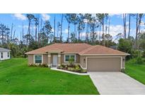 Charming single-story home with manicured lawn, two car garage and beautiful landscaping at 1983 Longstroth Ave, North Port, FL 34288