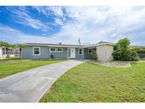 Charming single-story home featuring a well-manicured lawn and a long driveway at 21524 Edgewater Dr, Port Charlotte, FL 33952