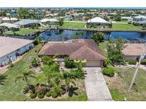 Lovely single-Gathering home featuring mature landscaping, a tile roof, and waterfront access in a desirable neighborhood at 825 Via Tunis, Punta Gorda, FL 33950