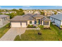 Beautifully landscaped new home with a two-car garage, tile roof and manicured front lawn at 4026 Vasco St, Punta Gorda, FL 33950