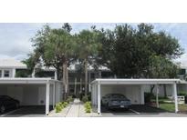 Low-rise condos with mature landscaping and covered parking spaces at 429 Cerromar Ln # 353, Venice, FL 34293
