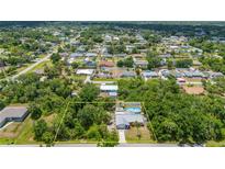 Sprawling property with a pool and lush landscaping in a quiet, residential neighborhood at 732 Haleybury St, Port Charlotte, FL 33948