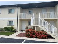 Well-maintained condo building with manicured landscaping and balcony access for upper units at 25275 Rampart Blvd # 207, Punta Gorda, FL 33983